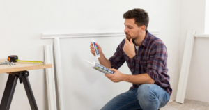 man wondering between caulk and glue for trim