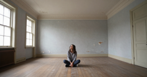 girl sitting middle of room thinking