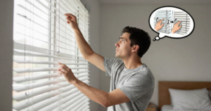 man adjusting blinds up and down
