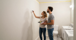 couple in paint prepped bathroom