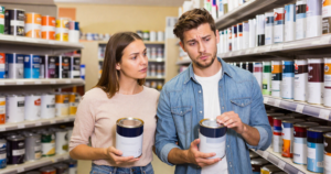 couple comparing paint in paint store