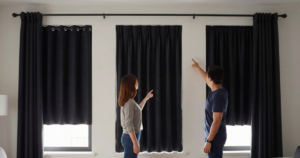 couple looking at blackout curtain options