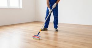 man staining floor in empty room