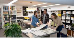 people in atelier with wallpaper rolls
